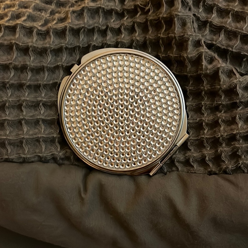 Sliver portable mirror with gems on it